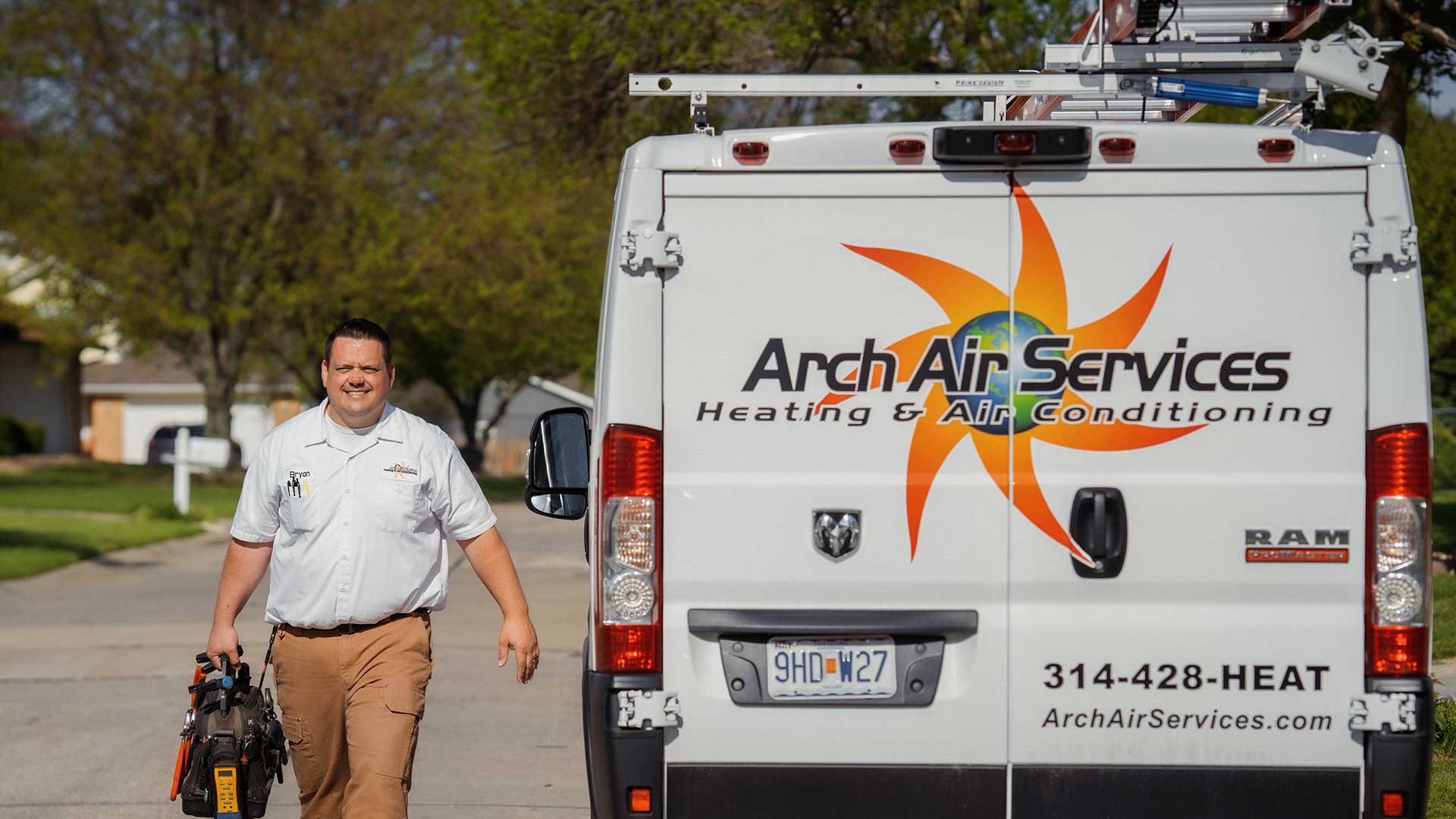 arch air service technician walking next to company truck